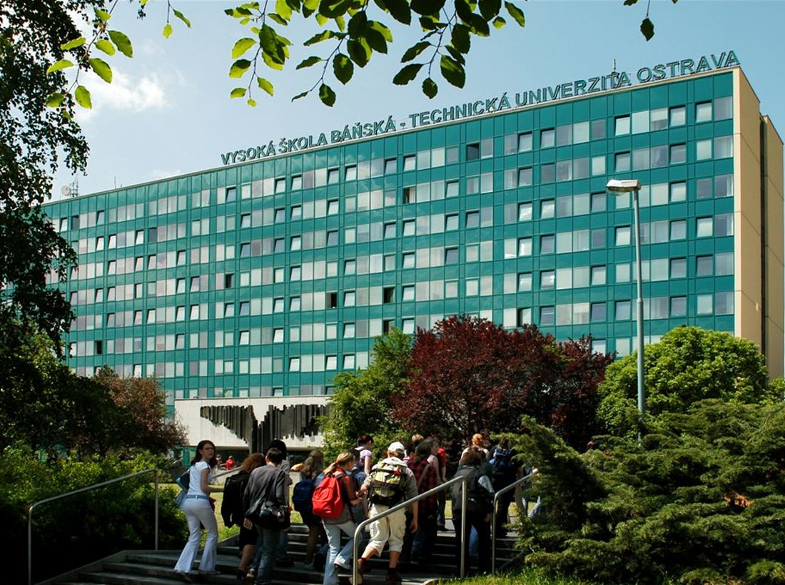 Students on the steps of VSB – Technical University of Ostrava, the building's name across its facade